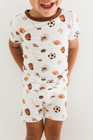In My Jammers Two Piece Short Set - Sports
Child wearing a pajama set with sports-themed print on a plain background