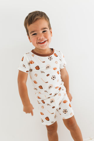 In My Jammers Two Piece Short Set - Sports
Child wearing a white romper with sports-themed print on a plain background