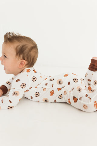 In My Jammers Zipper Romper - Sports
Baby wearing pajamas with sports-themed print on a white background
