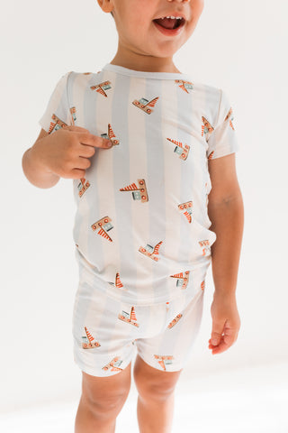 In My Jammers Two Piece Short Set - Little Sailboat
Child wearing a white romper with orange patterns on a plain background