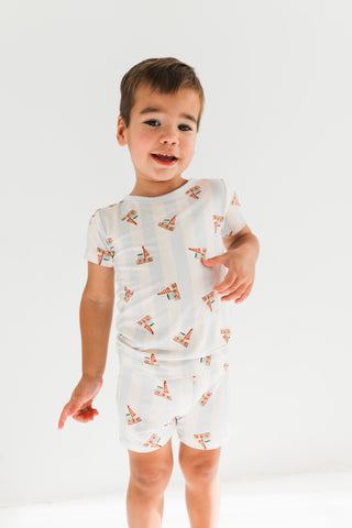 In My Jammers Two Piece Short Set - Little Sailboat
Child wearing a white pajama set with cartoon foxes on a plain background