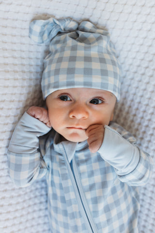 In My Jammers Blue Gingham Newborn Hat
Baby wearing a blue and white checkered hat and onesie on a textured surface