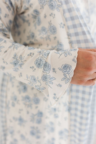 In My Jammers Blue Rose Garden Women's Robe
Close-up of a person wearing a floral-patterned outfit with a checkered background