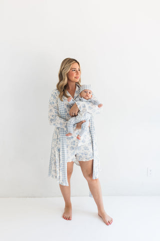 In My Jammers Blue Rose Garden Women's Robe
Woman in a checkered robe holding a baby against a white background