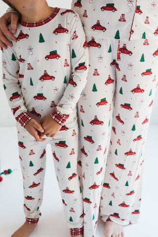 In My Jammers Red Holly Jolly Cruisers Two Piece Set
Children's pajamas with Christmas car and tree pattern on a white background