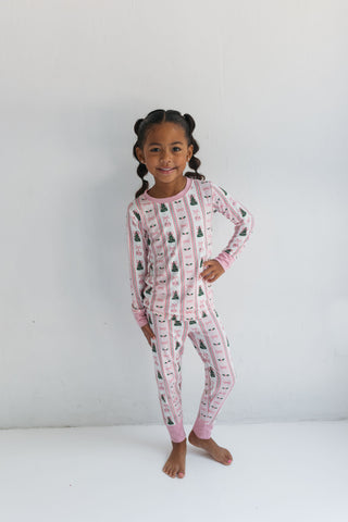 In My Jammers Pinkmas Two Piece Set 
Child wearing pink pajamas with a pattern on a white background
