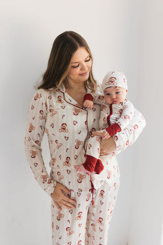 In My Jammers Bear-y Merry Women’s Set
Woman wearing a matching pajama set with a baby in a red outfit against a white background