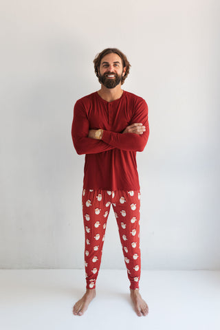 In My Jammers Santa Men's Jogger
Man wearing red pajama set with white paw prints on a plain background
