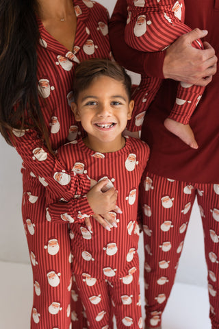 In My Jammers Santa Men's Jogger
Family wearing matching red pajamas with Santa Claus pattern on a white background