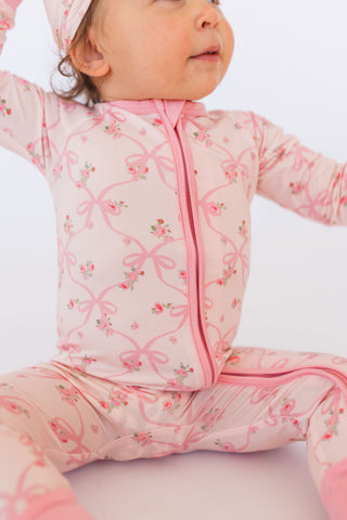 In My Jammers Rosie Bow zipper romper pajamas featuring a playful design, soft fabric, and a front zipper for comfort.