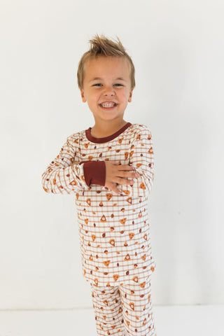 In My Jammers Two Piece Set - Spiced Pie
Child wearing a patterned pajama set with a plain background