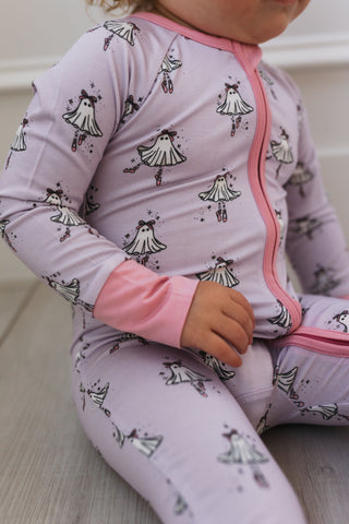In My Jammers Ballerina Ghost Zipper Romper Baby wearing a light purple outfit with black and white patterns on a neutral background