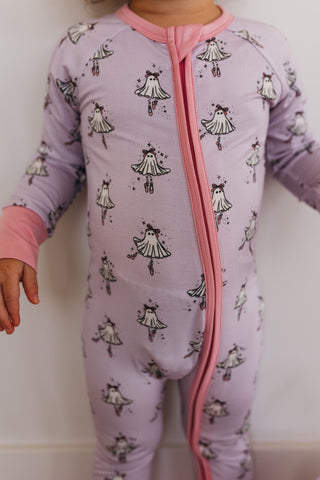 In My Jammers Ballerina Ghost Zipper Romper Child wearing a purple onesie with black and white patterns on a plain background