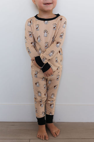In My Jammers DJ BooMBox Two Piece Set Child wearing beige pajamas with animal print against a white wall