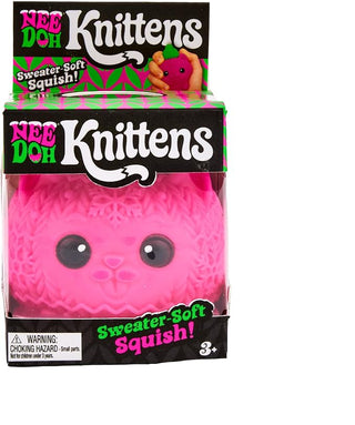 NeeDoh Squishmas Knittens
Nee Doh Knittens Sweater-Soft Squishy toy in its retail packaging, featuring a bright pink knitted bear face with large black eyes. The packaging is black with green and white branding, and a black banner at the bottom states 'colors & style may vary (1 per pack)'.