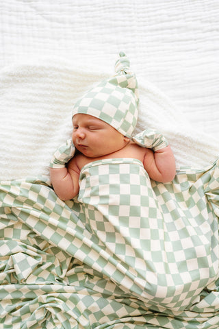 Lou Lou and Company Knit Swaddle Blanket in Kirby pattern, soft and cozy for newborns, featuring colorful knit design.