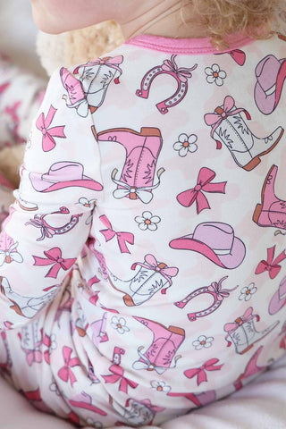 Caden Lane Rodeo Dreams pink two-piece pajama set for kids, featuring playful print and soft fabric for comfortable sleepwear.