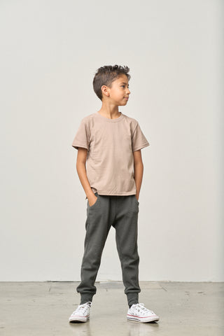 Little Bipsy Elevated Tee - Mushroom
Child wearing a beige t-shirt and gray pants against a plain background