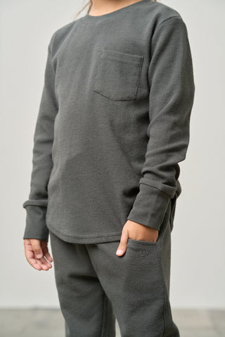 Little Bipsy Waffle Top - Shadow
Person wearing a gray long-sleeve shirt and pants against a white background