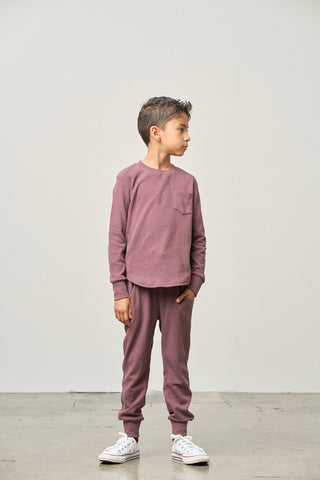 Little Bipsy Waffle Jogger - Huckleberry
Child wearing a mauve long-sleeve shirt and pants with white sneakers on a plain background
