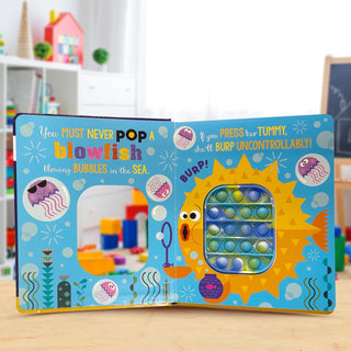 Never Pop a Shark! Board Book
Colorful children's book with bubble pop feature on a wooden surface