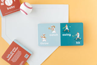 Left Hand Book House Baseball Baby board book featuring colorful illustrations of a baby and baseball themed images.