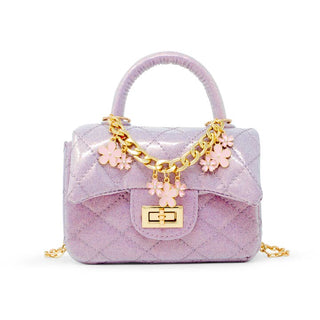 Zomi Gems Classic Sparkle Top Handle Handbag - Baby Purple
Lavender quilted handbag with gold chain and flower charms on a white background