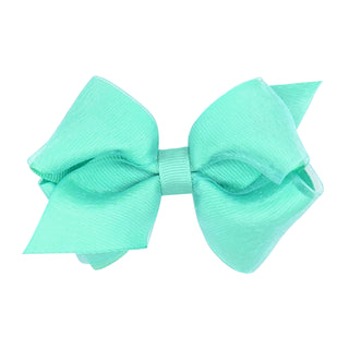 Little girl wearing an aqua extra small overlay grosgrain bow hair clip from Wee Ones, styled in her hair.