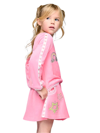 Baby Sara Pink Velour Skirt with Rhinestone Detail
Young girl wearing a pink dress with decorative elements on a light gray background