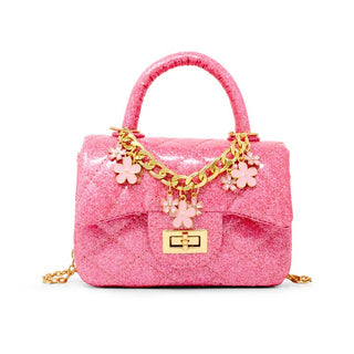Zomi Gems Classic Sparkle Top Handle Handbag - Pink Lemonade
Pink glitter handbag with gold chain and flower charms on a white background