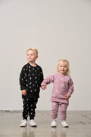 Little Bipsy Lightning Bolt Pullover - Black
Two children wearing matching outfits against a plain background