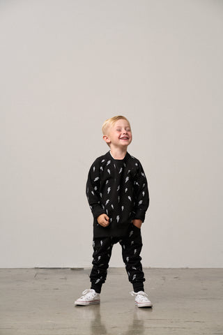 Little Bipsy Lightning Bolt Pullover - Black
Child wearing a black outfit with white patterns on a plain background