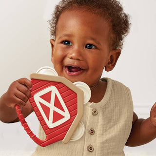 Itzy Ritzy Itzy Bitzy Jamboree™
Child holding a red and beige toy with a smile on a plain background