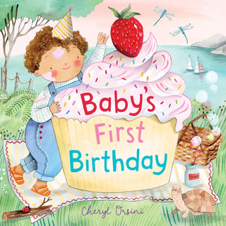 Hachette Baby’s First Birthday Board Book 
Book cover of 'Baby's First Birthday' with a child in a birthday hat on a large cupcake, surrounded by nature.