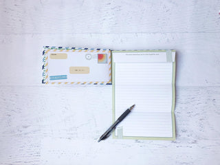 Letters to My Son: Write Now. Read Later.
Notepad, pen, and envelope on a light wooden surface