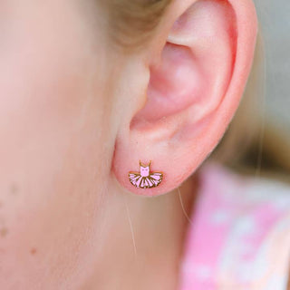 Pierced Co. Tutu Earrings 
Close-up of an ear wearing a pink ballet slipper earring with a blurred background