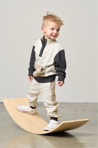 Little Bipsy Colorblock Mockneck Pullover - Stone Grey
Little Bipsy Side Stripe Jogger - Stone Grey
Child standing on a wooden balance board against a plain background