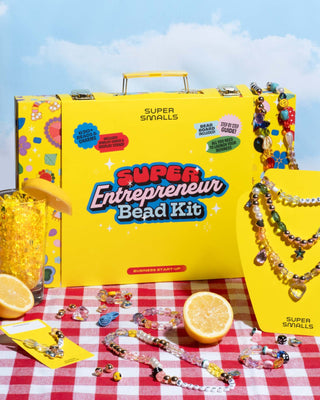 Super Smalls Super Entrepreneur Bead Kit Super Entrepreneur Bead Kit by Super Smalls on a red and white checkered tablecloth with lemons.