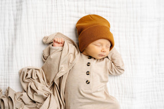 Lou Lou and Company Top and Bottoms - Ryan
Newborn baby sleeping in a beige outfit with a brown hat on a white background
