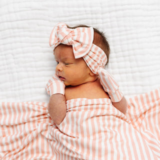 Lou Lou and Company Headband - Brynn
Newborn baby wrapped in a pink and white striped blanket with a matching headband on a white background
