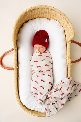 Lou Lou and Company Knit Swaddle Blanket in Marshal color, soft knit fabric with a cozy, textured pattern for baby comfort.