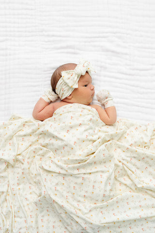 Lou Lou and Company Swaddle Blanket - Willow
Newborn baby wrapped in a white blanket with a bow on a white background