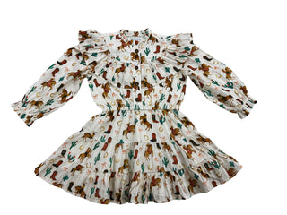 Alto Modas Girls Audrey Dress - Western 
A white tiered ruffle dress with a long-sleeve puff sleeve and a smocked waist, featuring an all-over western print of brown horses, green cacti, and orange horseshoes.