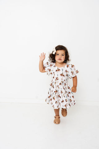 Alto Modas Girls Daphne Dress - Western
Child wearing a floral dress on a white background