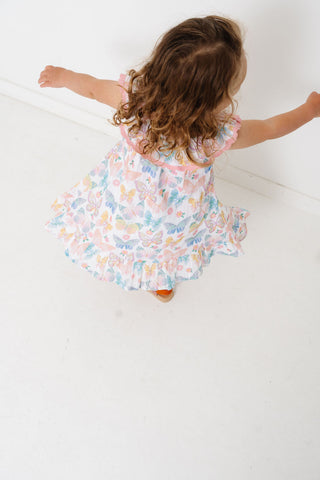 Alto Modas Girls Harper Dress - Butterflies
Child in a floral dress standing on a white floor
