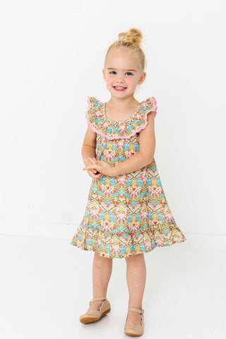 Alto Modas Girls Harper Dress - Happy Sun
Young girl wearing a colorful floral dress on a white background