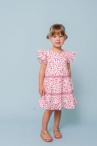 Alto Modas Girls Twirl Dress - Hearts Print
Young girl wearing a pink floral dress against a light blue background