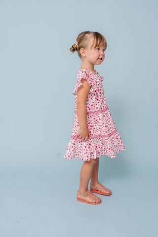 Alto Modas Girls Twirl Dress - Hearts Print
Young girl wearing a pink floral dress against a light blue background