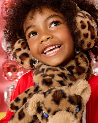 Super Smalls Jungle Jeweled Earmuffs
Child wearing a leopard print hat and scarf with a red background