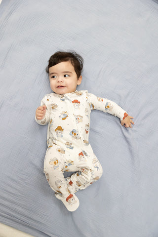 Angel Dear 2 Way Zipper Footie - Cowdogs
Baby lying on a gray blanket wearing a patterned onesie.